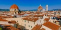 Florence Cathedral, Giotto`s Bell Tower, and San Lorenzo Basilica under blue sky, over houses of the historical center of Florenc