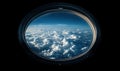 View of fluffy clouds from spacecraft window against deep blue sky Royalty Free Stock Photo