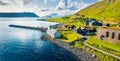 View from flying drone. Aerial summer view of Kirkjubour villagewith Hestur Island on background. Picturesque morning scene of Far