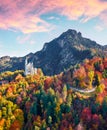 View from flying drone. Amazing autumn scene of Neuschwanstein Castle, 19th-century hilltop fairytale castle. Great morning scene