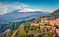 View from flying drone. Beautiful morning view of Taormina town and Etna volcano on background. Splendid summer view of Sicily, It