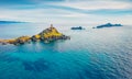 View from flying drone. Beautiful summer scene of popular tourist destination Torra di a Parata - 16th-century Genoese tower reach