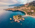 View from flying drone. Breathtaking morning view of Bella island and Etna volcano on background. Nice spring seascape of Mediterr