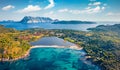 View from flying drone. Breathtaking spring scene of Salina Bamba beach with Tavolara mountain on background. Captivating morning