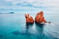 View from flying drone. Calm spring view of Red Rocks Gli Scogli Rossi - Faraglioni on the di Cea beach. Aerial morning scene of S