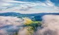 View from flying drone of Carpathian mountains with huge fog spreds on the valley, Ukraine,