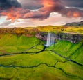 View from flying drone. Fabulous summer view of Seljalandsfoss waterfall. Wonderful sunrise in Iceland, Europe. Beauty of nature c Royalty Free Stock Photo