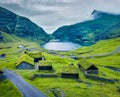 View from flying drone. Green summer scene of Saksun village with typical turf-top houses and Saksunar Kirkja, Faroe Islands. Nice