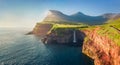 View from flying drone. Majestic morning scene of Mulafossur Waterfall. Stunning summer view of Vagar island, Faroe Islands, Denm