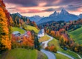 View from flying drone of Maria Gern church with Hochkalter peak on background. Splendid autumn sunset on Bavarian Alps. Colorful