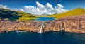 View from flying drone. Panoramic morning view of Bosdalafossur waterfall, that falls directly into the ocean. Exciting summer sce