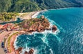 View from flying drone. Sunny morning cityscape of Porto town with Genoise de Porto Ota tower. Aerial spring view of Corsica islan