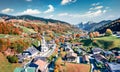 View from flying drone. Sunny morning scene of Parish Church of St. Sebastian. Picturesque autumn view of Bavarian Alps, Au villag