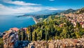 View from flying drone. Sunny morning view of Taormina town and Etna volcano on background. Splendid spring seascape of Mediterran