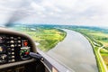 View from a flying sport plane over river landscape Royalty Free Stock Photo