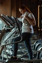 View of focused overweight girl training on stepper while holding towel