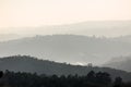 View of foggy forests in degrade mountains, several gray scale planes fading into the horizon Royalty Free Stock Photo