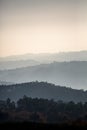 View of foggy forests in degrade mountains, several gray scale planes fading into the horizon Royalty Free Stock Photo