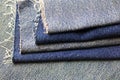 STACKED PIECES OF FOLDED BLUE FRAYED DENIM CLOTH Royalty Free Stock Photo