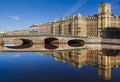 View of the Fontanka river with Izmailovsky bridge, profitable houses on the waterfront and their mirror image in the water. Saint