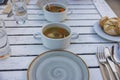 View of food plates on white wooden table. Eating out concept.