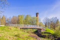 View at a footbridge by an observation tower with lush green trees at springtime Royalty Free Stock Photo