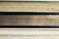 View on fore edge of isolated stacked old yellowed books with copy space for text