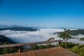 View of forest, mountains and wooden deck with fog in morning at Huai Kub Kab