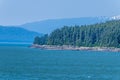 A view of the forested shoreline looking up the Gastineau Channel on the approach to Juneau, Alaska