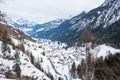 View form above of small mountain town covered in snow on a cloudy winter day Royalty Free Stock Photo
