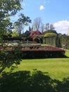 View of formal gardens with a church in the distance in East Sussex, UK. Royalty Free Stock Photo