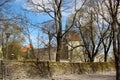 View of the fortress walls and towers of old Tallinn through the trees in the park. Royalty Free Stock Photo