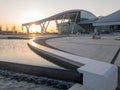 View of the fountain and the left wing of the modern and comfortable airport named Platov at sunset