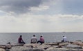 View of four men sitting on the rocks