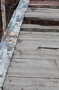 Wooden bridge with several gaps in it and one board painted in red