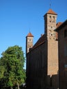 View of a fragment of a brick wall of a medieval castle with two loophole towers ..