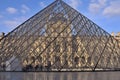 View fragments of Louvre buildings and pyramid in main courtyard Cour Napoleon of Louvre Museum. Louvre Museum is one of largest