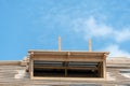 View of the frame of a new wooden roof made of thick beams. Repair of a sloping roof in a country house. Construction site on a Royalty Free Stock Photo