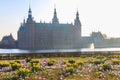 View of Frederiksborg castle in Hillerod, Denmark. Beautiful lake and garden with crocuses and daffodils on a foreground Royalty Free Stock Photo