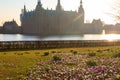 View of Frederiksborg castle in Hillerod, Denmark. Beautiful lake and garden with crocuses and daffodils on a foreground Royalty Free Stock Photo