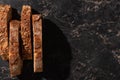 View of fresh bread slices on stone black surface Royalty Free Stock Photo