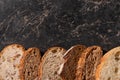 View of fresh bread slices on stone black surface Royalty Free Stock Photo