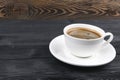 View of a freshly brewed mug of espresso coffee on rustic wooden background with woodgrain texture. Coffee break style, concept. Royalty Free Stock Photo