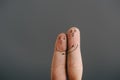 View of frightened couple of fingers hugging and screaming isolated on grey