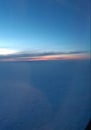 The view frombthe airplane. Sunrise. Clouds and sun. Beautiful view from the plane.