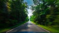 View from front of blue car on asphalt road and speed motion blur on highway in summer with green trees forest Royalty Free Stock Photo