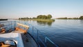 View from the front deck of the ship to a branching river on a quiet summer evening