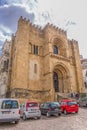 View of front facade of the gothic building of Coimbra Cathedral, Coimbra city and sky as background