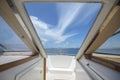 view of front luxury speedboat with a beautiful ocean and mountain in background