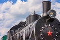 View of the front of the old steam locomotive with the smokestack, headlight and smokebox door